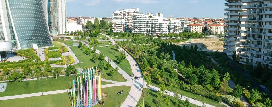 An aerial view of a large park between office buildings.