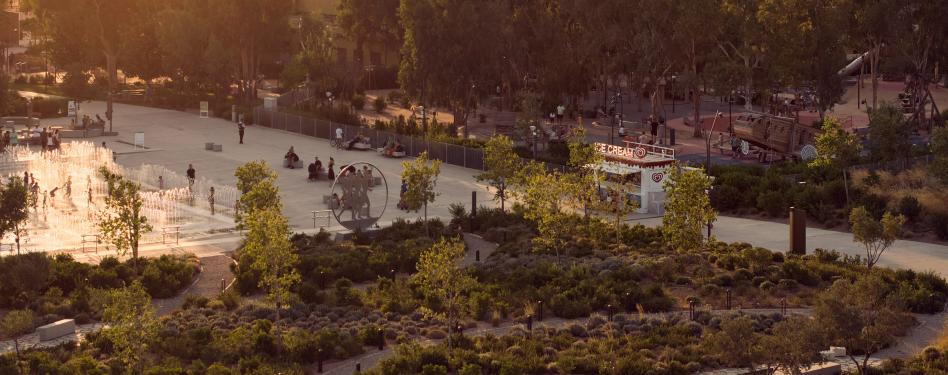 An aerial view of a large park and water feature.