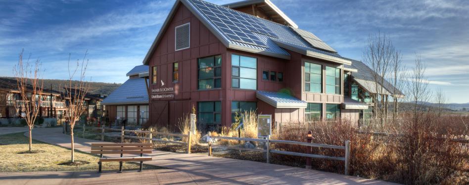 A modern structure amid prairie grasses.
