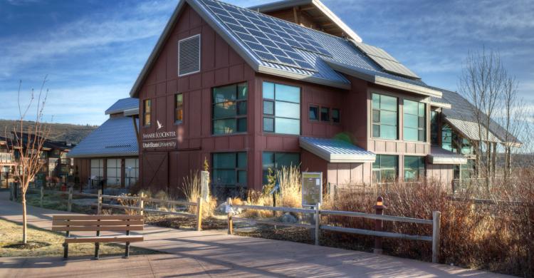 A modern structure amid prairie grasses.